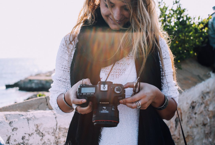 Happy Solo Traveler Capturing Memories with a Camera